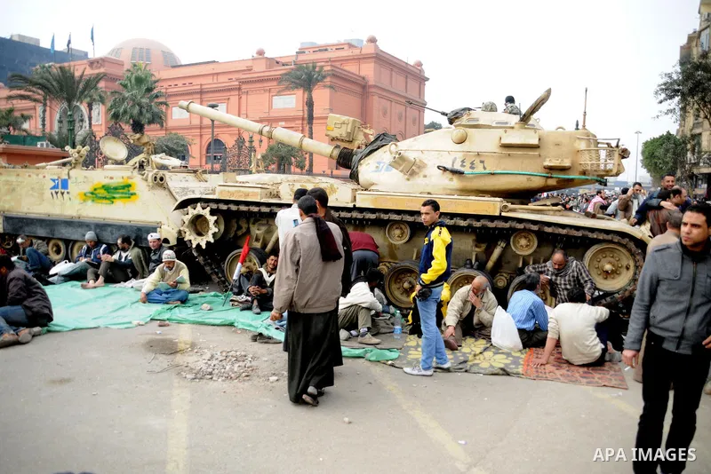 Anti-government protesters take part in demonstrations in Tahrir Square in downtown Cairo, Egypt, Tuesday, Feb. 8, 2011. Protesters appear to have settled in for a long standoff, turning Tahrir Square into a makeshift vi...