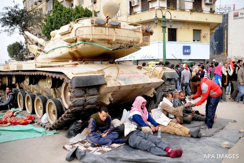 Anti-government protesters take part in demonstrations in Tahrir Square in downtown Cairo, Egypt, Tuesday, Feb. 8, 2011. Protesters appear to have settled in for a long standoff, turning Tahrir Square into a makeshift vi...