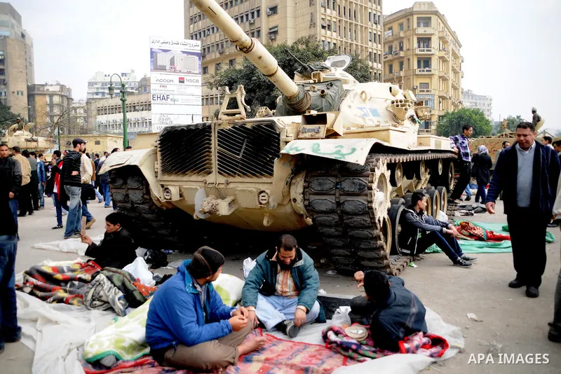 Anti-government protesters take part in demonstrations in Tahrir Square in downtown Cairo, Egypt, Tuesday, Feb. 8, 2011. Protesters appear to have settled in for a long standoff, turning Tahrir Square into a makeshift vi...