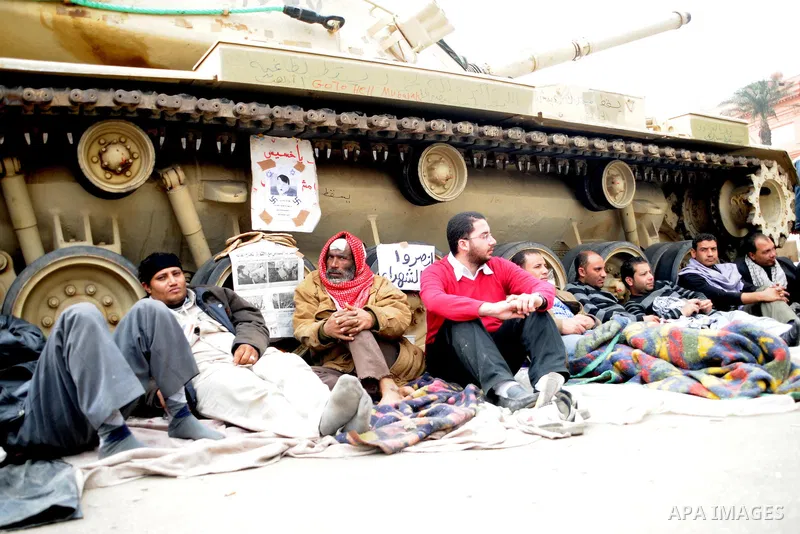 Anti-government protesters take part in demonstrations in Tahrir Square in downtown Cairo, Egypt, Tuesday, Feb. 8, 2011. Protesters appear to have settled in for a long standoff, turning Tahrir Square into a makeshift vi...