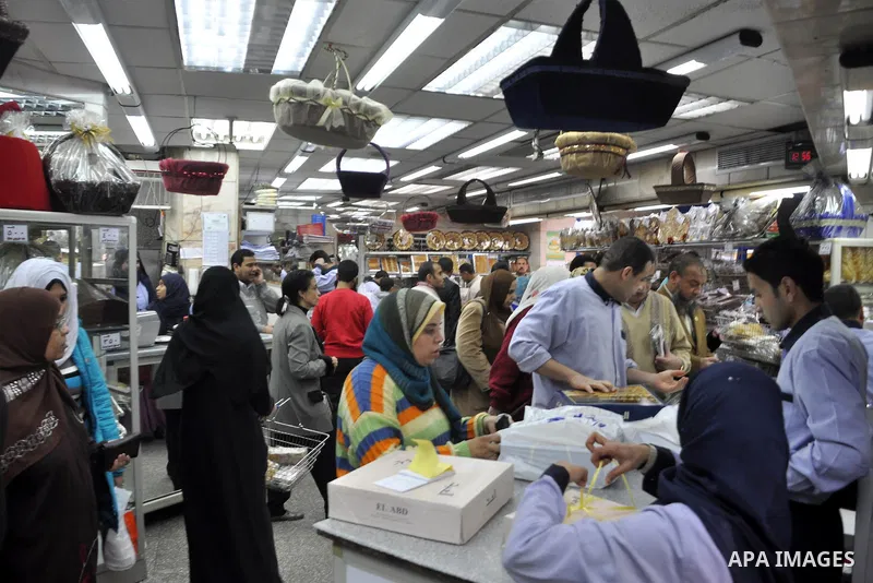 Egyptians shop at a mall in Cairo, Egypt, Tuesday, Feb. 8, 2011. Protesters appear to have settled in for a long standoff, turning Tahrir Square into a makeshift village with tens of thousands coming every day, with some...