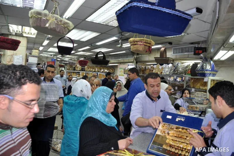 Egyptians shop at a mall in Cairo, Egypt, Tuesday, Feb. 8, 2011. Protesters appear to have settled in for a long standoff, turning Tahrir Square into a makeshift village with tens of thousands coming every day, with some...