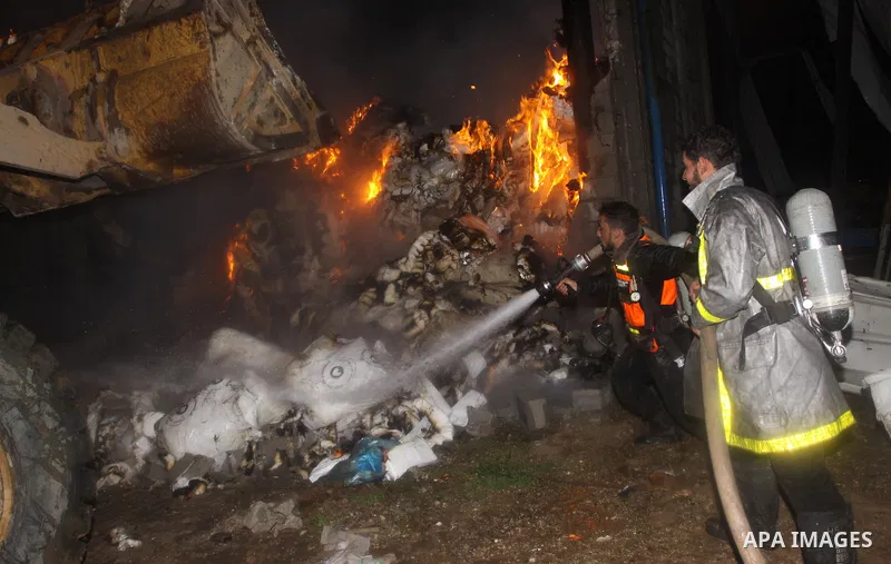 Palestinian firefighters try to extinguish a fire at a burning medicine warehouse in Gaza City, Wednesday, Feb. 9, 2011. Early Wednesday, Israeli aircraft carried out air strikes against four targets including Hamas and...