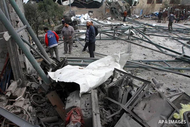 Palestinians inspect burnt a medical storage facility a day after it was set on fire following an Israeli air strike in Jabalia, northern Gaza Strip, on February 9, 2011. Photo by Ashraf Amra