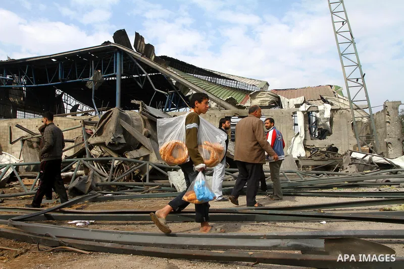 Palestinians inspect burnt a medical storage facility a day after it was set on fire following an Israeli air strike in Jabalia, northern Gaza Strip, on February 9, 2011. Photo by Ashraf Amra