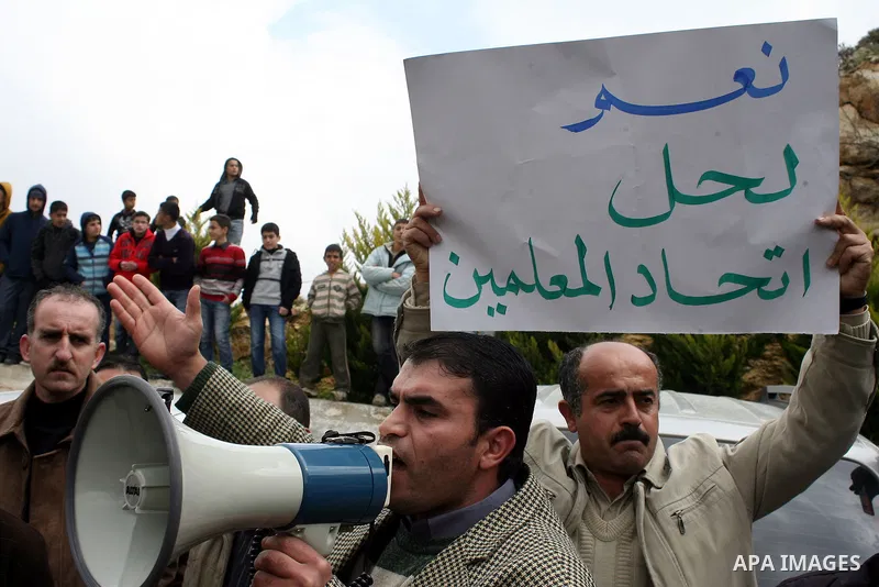 Palestinian teachers take part in a demonstration outside the office of the Directorate of Education in the West Bank town of Halhoul, north of Hebron on Feb. 9,2011. Photo by Najeh Hashlamoun