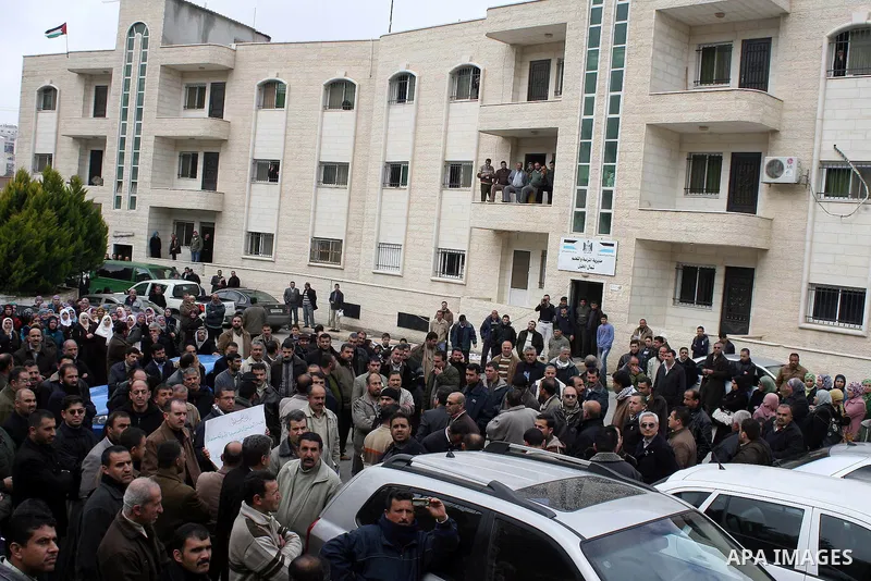 Palestinian teachers take part in a demonstration outside the office of the Directorate of Education in the West Bank town of Halhoul, north of Hebron on Feb. 9,2011. Photo by Najeh Hashlamoun