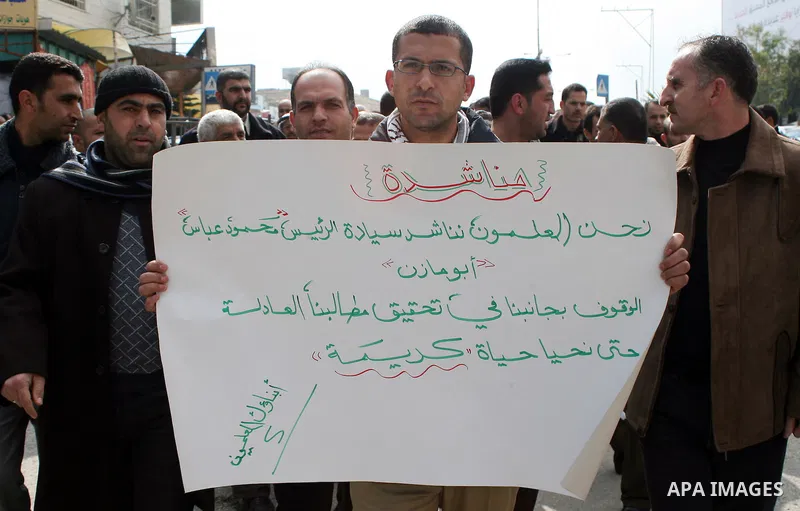Palestinian teachers take part in a demonstration outside the office of the Directorate of Education in the West Bank town of Halhoul, north of Hebron on Feb. 9,2011. Photo by Najeh Hashlamoun