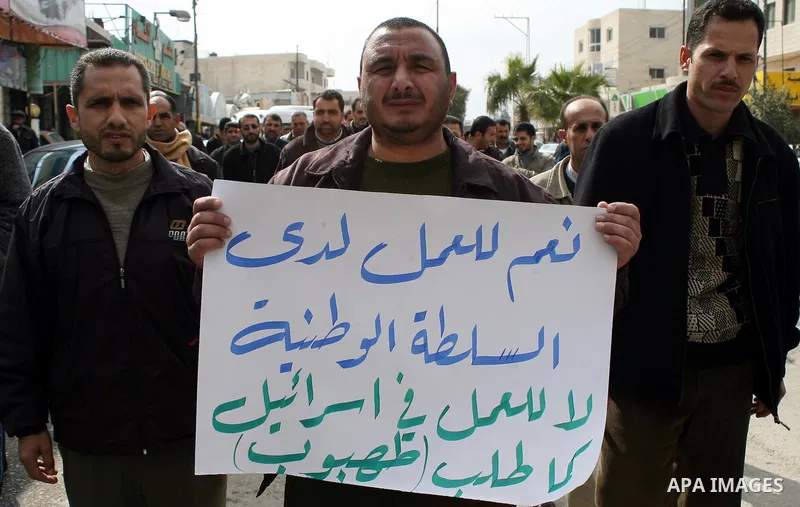 Palestinian teachers take part in a demonstration outside the office of the Directorate of Education in the West Bank town of Halhoul, north of Hebron on Feb. 9,2011. Photo by Najeh Hashlamoun