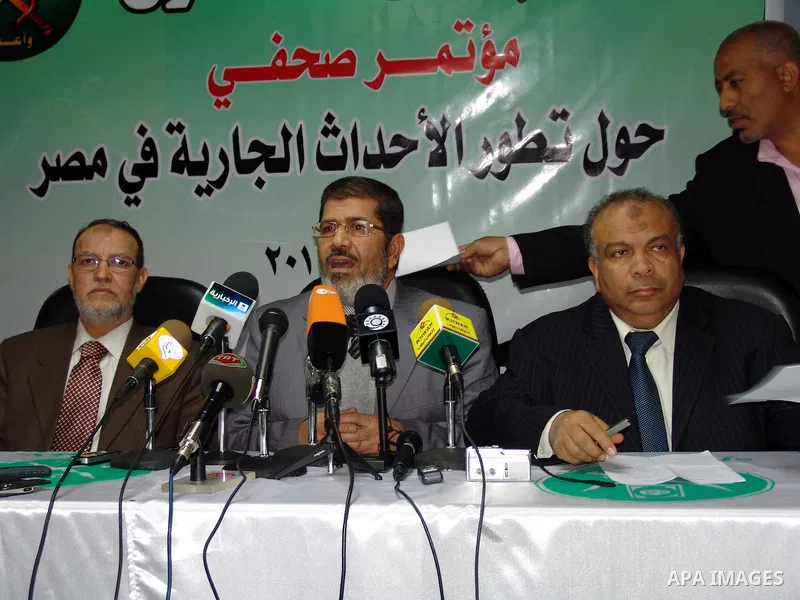 Egyptian Muslim brotherhood seniors Saad el-Katatni, right, Essam el-Erian, left, and Mohamed Morsi talk during a press conference in Cairo, Egypt, Wednesday, Feb. 9, 2011. The Muslim Brotherhood considered the Egypt's l...