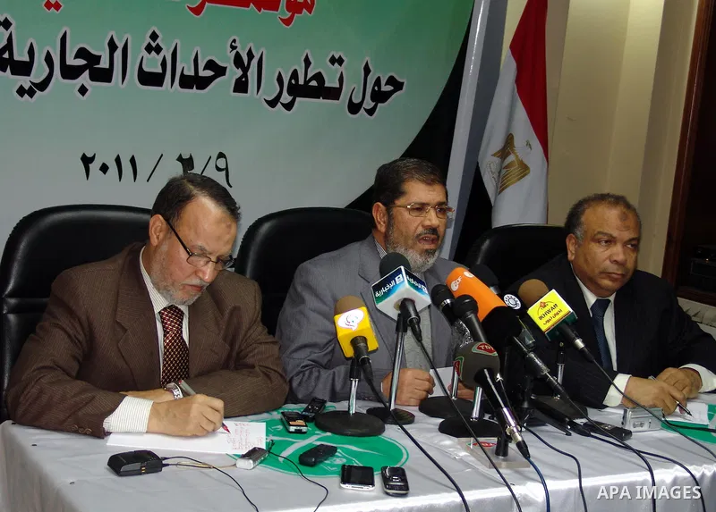 Egyptian Muslim brotherhood seniors Saad el-Katatni, right, Essam el-Erian, left, and Mohamed Morsi talk during a press conference in Cairo, Egypt, Wednesday, Feb. 9, 2011. The Muslim Brotherhood considered the Egypt's l...