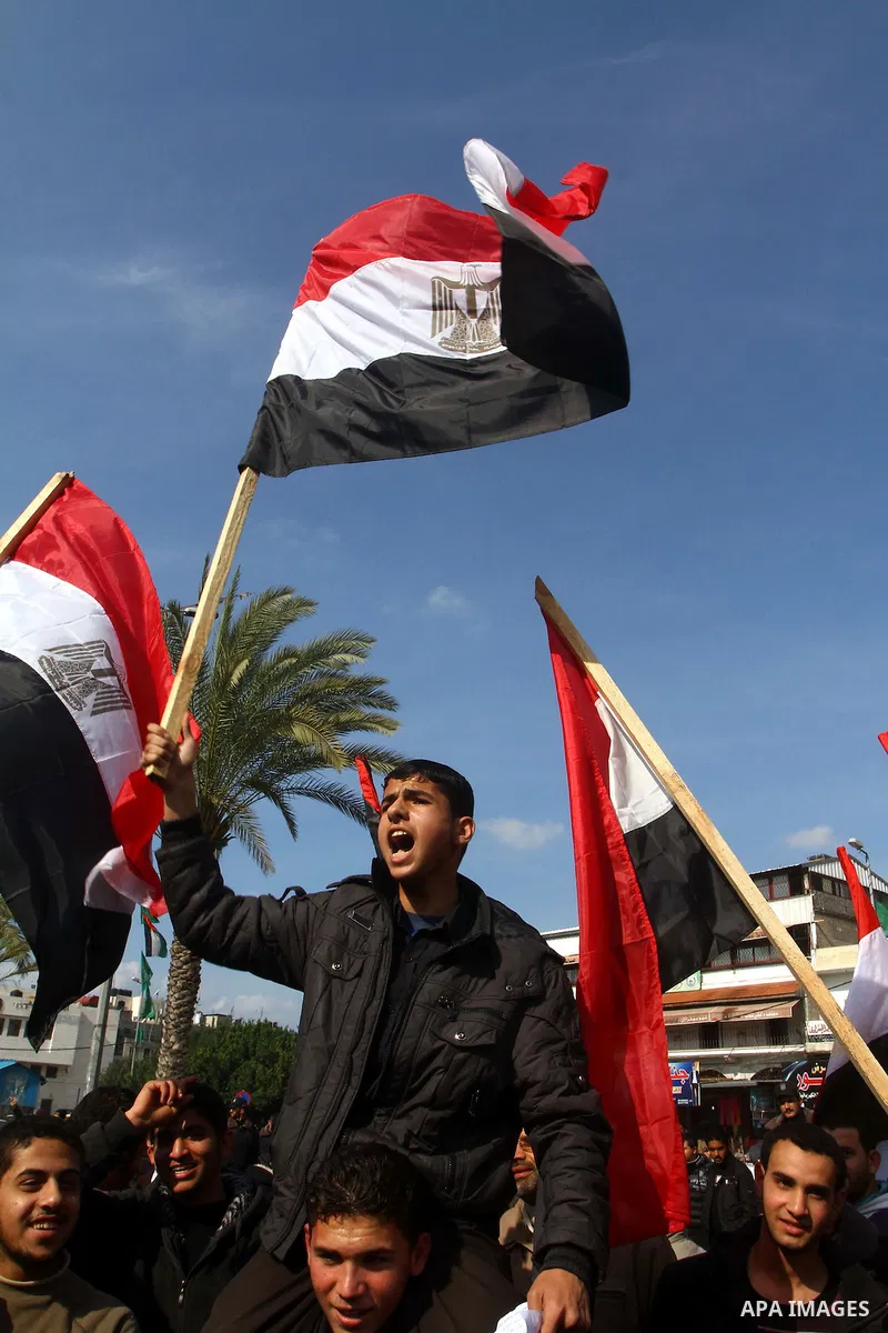 Palestinians display Palestinian and Egyptian flags during a demonstration calling for the ouster of Egyptian President Hosni Mubarak in Gaza City, Wednesday, Feb. 9, 2011. Photo by Ashraf Amra