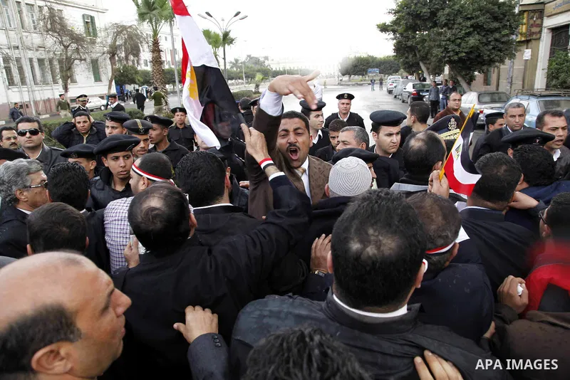 Egyptian protesters demonstrate at the gate of the presidential palace in Cairo, Egypt, Thursday, Feb. 10, 2011. Egypt's foreign minister warns of a military coup if protesters continue mass demonstrations and don't foll...