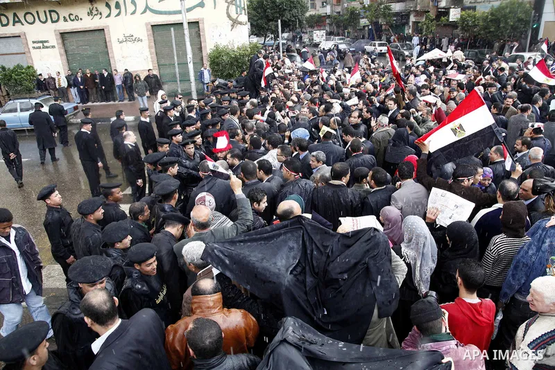 Egyptian protesters demonstrate at the gate of the presidential palace in Cairo, Egypt, Thursday, Feb. 10, 2011. Egypt's foreign minister warns of a military coup if protesters continue mass demonstrations and don't foll...