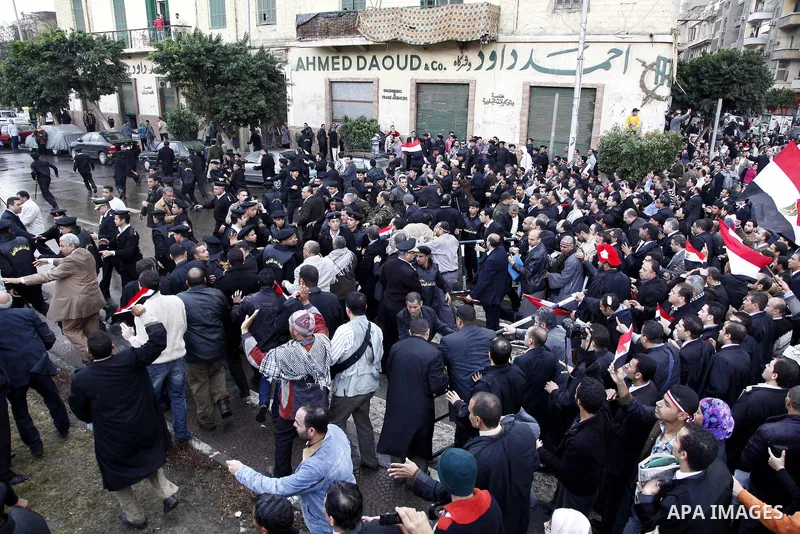 Egyptian protesters demonstrate at the gate of the presidential palace in Cairo, Egypt, Thursday, Feb. 10, 2011. Egypt's foreign minister warns of a military coup if protesters continue mass demonstrations and don't foll...