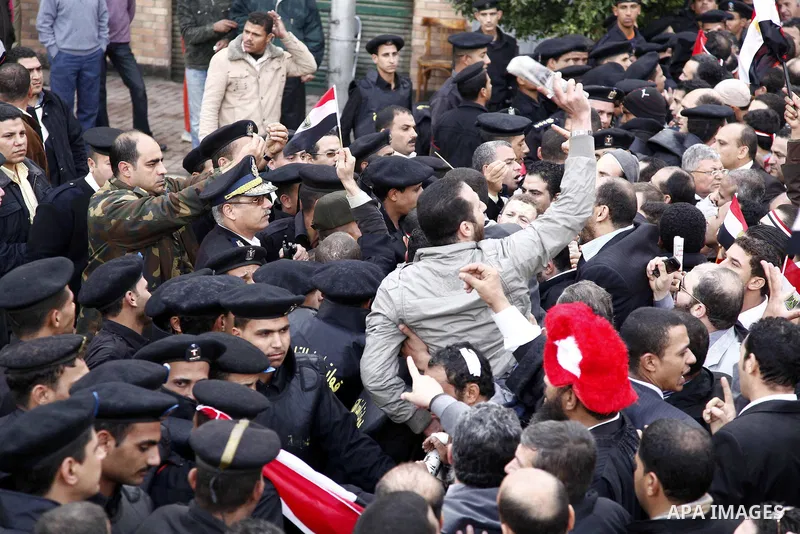 Egyptian riot police clashes with Egyptian protesters demonstrate at the gate of the presidential palace in Cairo, Egypt, Thursday, Feb. 10, 2011. Egypt's foreign minister warns of a military coup if protesters continue...