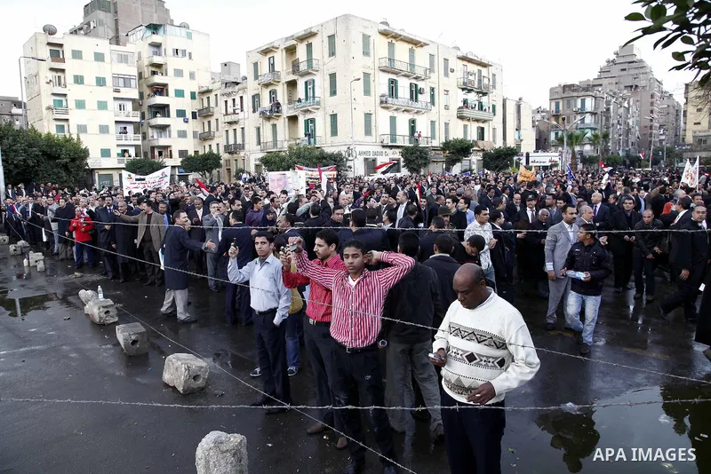 Egyptian protesters demonstrate at the gate of the presidential palace in Cairo, Egypt, Thursday, Feb. 10, 2011. Egypt's foreign minister warns of a military coup if protesters continue mass demonstrations and don't foll...