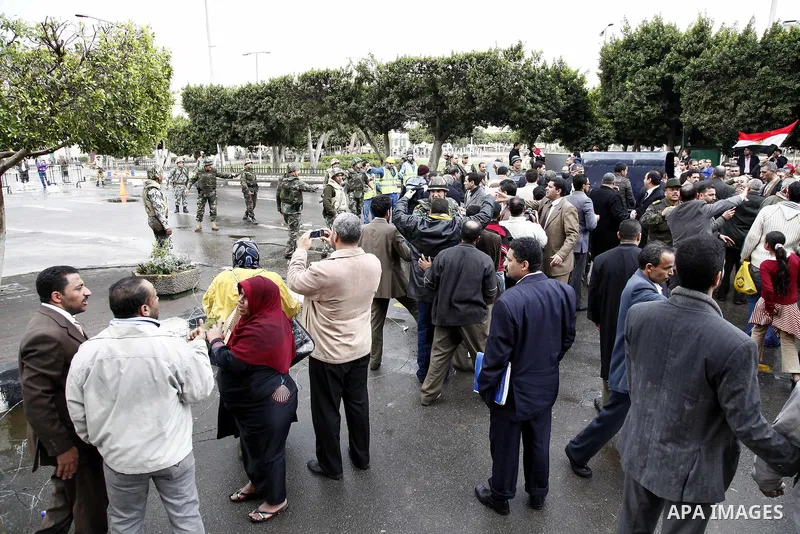 Egyptian riot police clashes with Egyptian protesters demonstrate at the gate of the presidential palace in Cairo, Egypt, Thursday, Feb. 10, 2011. Egypt's foreign minister warns of a military coup if protesters continue...