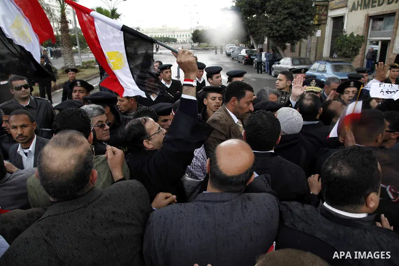 Egyptian riot police clashes with Egyptian protesters demonstrate at the gate of the presidential palace in Cairo, Egypt, Thursday, Feb. 10, 2011. Egypt's foreign minister warns of a military coup if protesters continue...