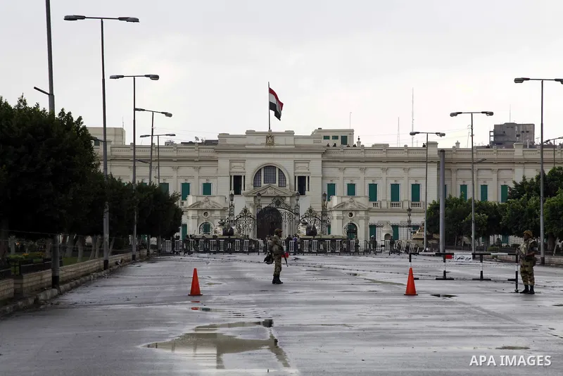 Egyptian soldiers stand guards as protesters demonstrate at the gate of the presidential palace in Cairo, Egypt, Thursday, Feb. 10, 2011. Egypt's foreign minister warns of a military coup if protesters continue mass demo...