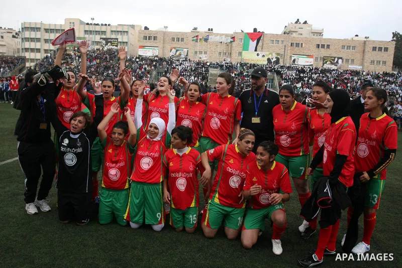 Palestinian Deyar players and Siryah Ramallah play in the opening soccer match of the Palestinian women's soccer league in the West Bank town of Aram, near Ramallah, Thursday, Feb. 10, 2011. Photo by Issam Rimawi