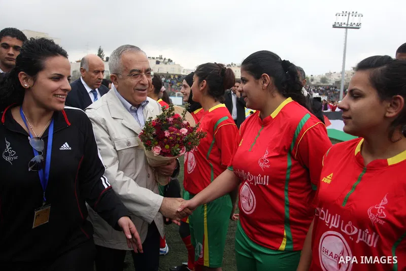 Palestinian prime minister Salam Fayyad participates the opening soccer match of the Palestinian women's soccer league between Siryah Ramallah and Deyar in the West Bank town of Aram, near Ramallah, Thursday, Feb. 10, 20...