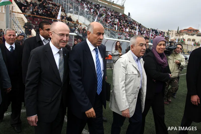 Palestinian prime minister Salam Fayyad participates the opening soccer match of the Palestinian women's soccer league between Siryah Ramallah and Deyar in the West Bank town of Aram, near Ramallah, Thursday, Feb. 10, 20...