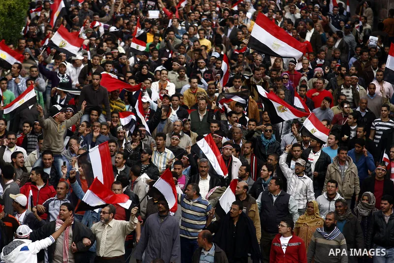 Egyptian anti-government protesters shout in front of Ettehadyya Presidential palace in Cairo, Egypt, Friday, Feb. 11, 2011. Egypt's military seemed to throw its weight Friday behind President Hosni Mubarak's plan to sta...