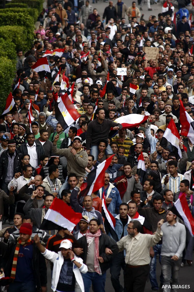 Egyptian anti-government protesters shout in front of Ettehadyya Presidential palace in Cairo, Egypt, Friday, Feb. 11, 2011. Egypt's military seemed to throw its weight Friday behind President Hosni Mubarak's plan to sta...