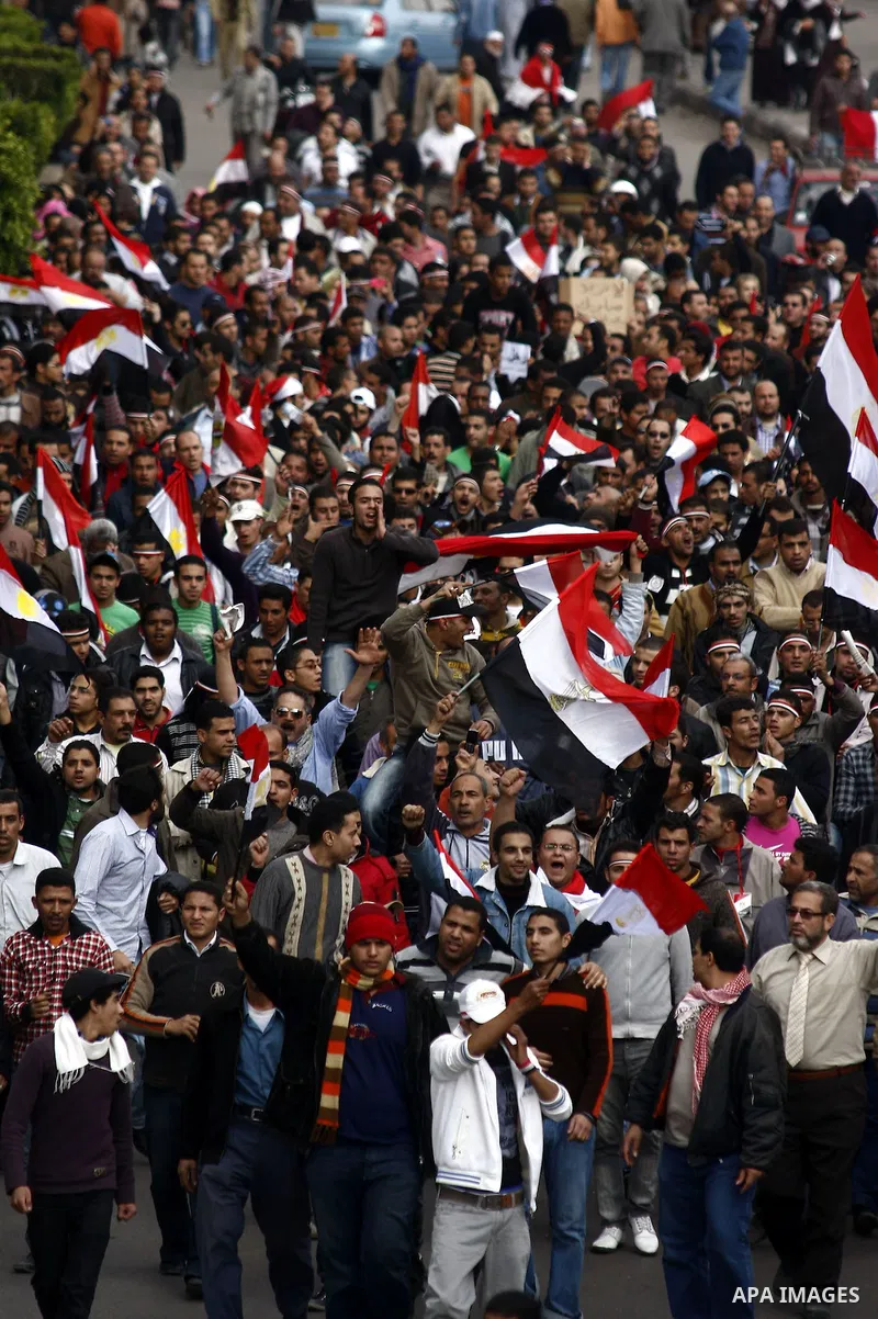 Egyptian anti-government protesters shout in front of Ettehadyya Presidential palace in Cairo, Egypt, Friday, Feb. 11, 2011. Egypt's military seemed to throw its weight Friday behind President Hosni Mubarak's plan to sta...