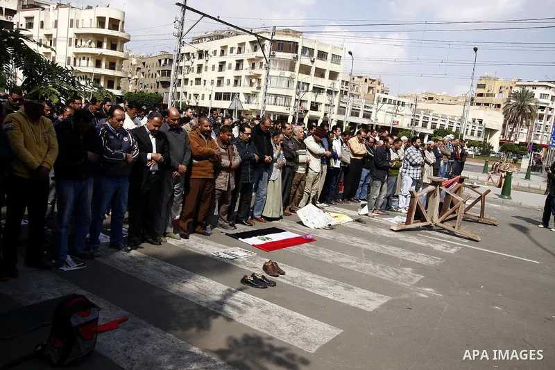 Egyptian protesters pray as the army block the entrence to Ettehadyya Presidential palace by barbed wire in Cairo, Egypt, Friday, Feb. 11, 2011. Egypt's military seemed to throw its weight Friday behind President Hosni M...