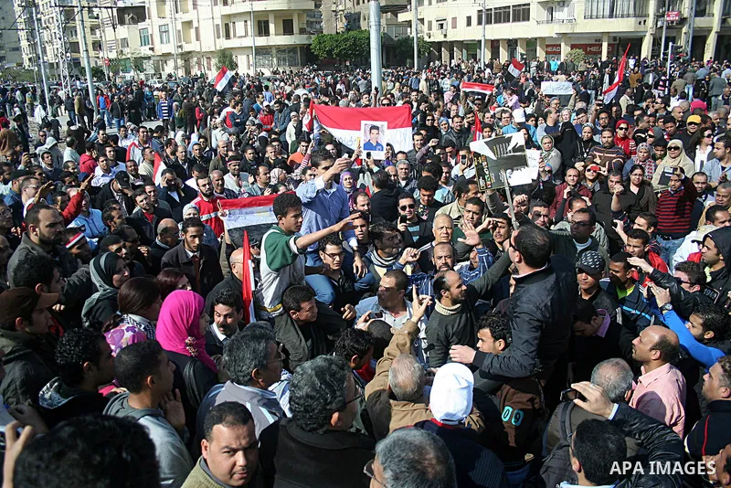 Egyptian anti-government protesters shout in front of Ettehadyya Presidential palace in Cairo, Egypt, Friday, Feb. 11, 2011. Egypt's military seemed to throw its weight Friday behind President Hosni Mubarak's plan to sta...