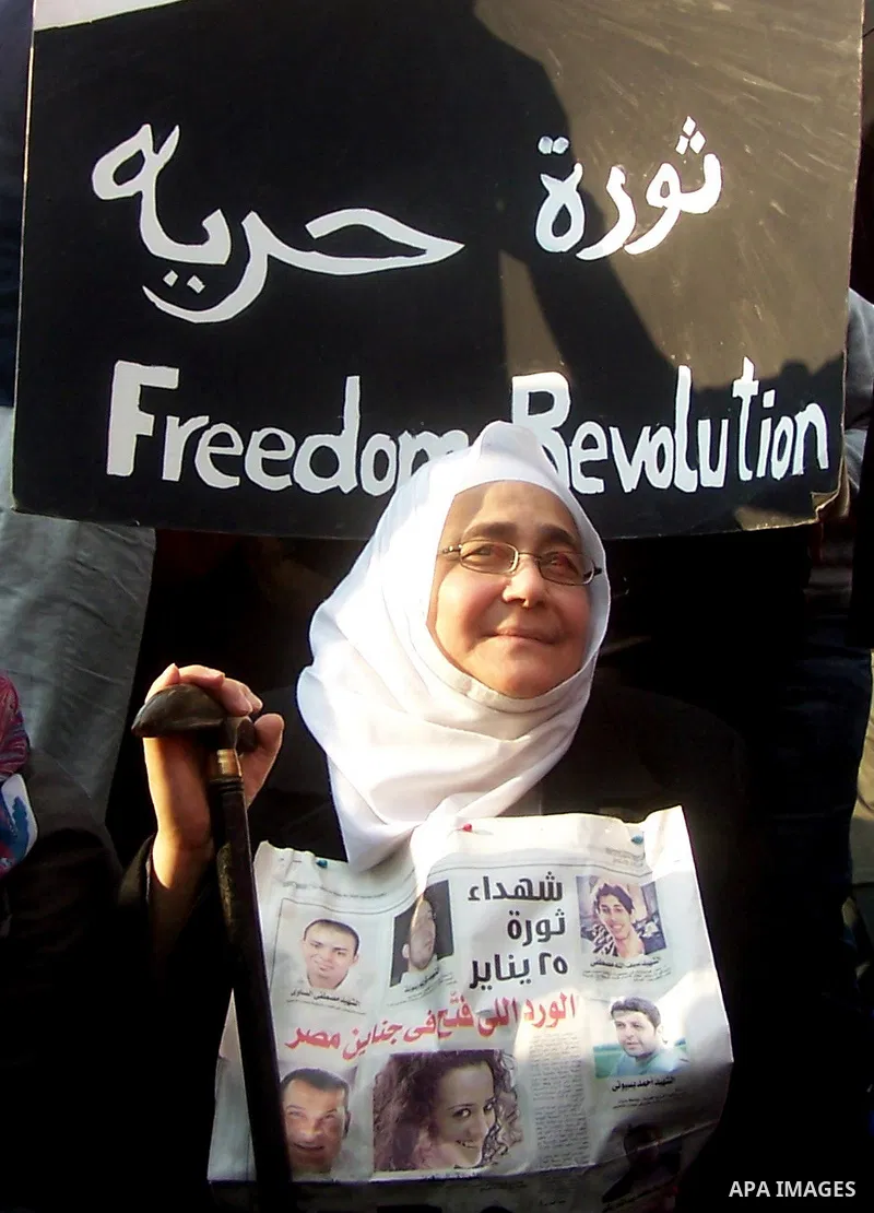 Anti-government protesters gather in front the state television building in Cairo, Egypt, Friday, Feb. 11, 2011. Mubarak has refused to step down or leave the country, and instead handed his administrative powers to his...