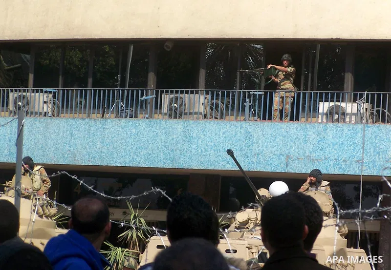 Anti-government protesters gather in front the state television building in Cairo, Egypt, Friday, Feb. 11, 2011. Mubarak has refused to step down or leave the country, and instead handed his administrative powers to his...