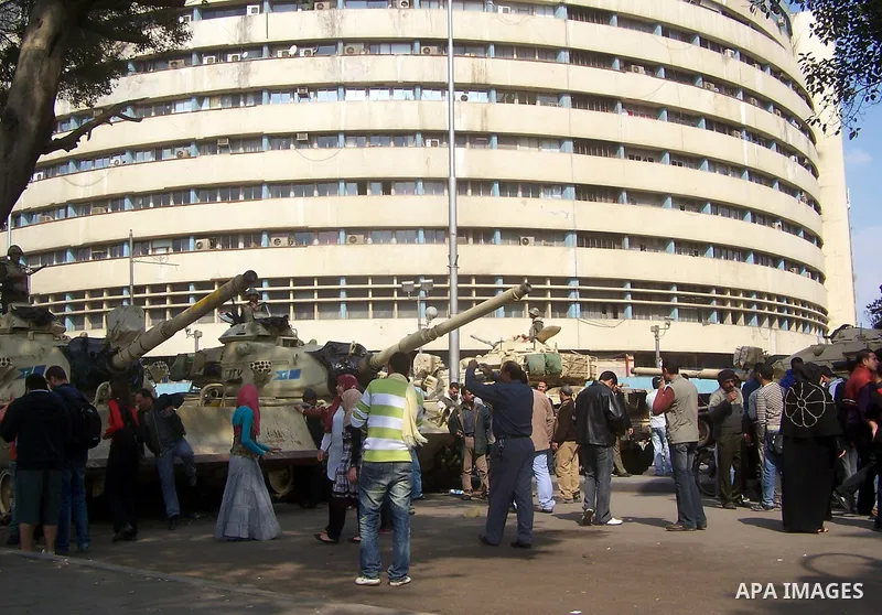 Anti-government protesters gather in front the state television building in Cairo, Egypt, Friday, Feb. 11, 2011. Mubarak has refused to step down or leave the country, and instead handed his administrative powers to his...