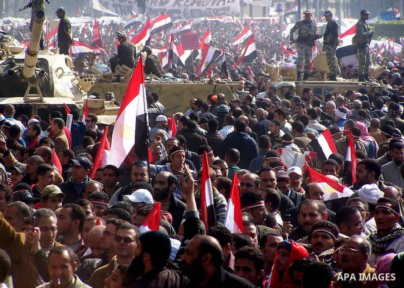 Anti-government protesters gather in front the state television building in Cairo, Egypt, Friday, Feb. 11, 2011. Mubarak has refused to step down or leave the country, and instead handed his administrative powers to his...