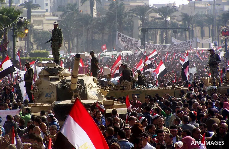 Anti-government protesters gather in front the state television building in Cairo, Egypt, Friday, Feb. 11, 2011. Mubarak has refused to step down or leave the country, and instead handed his administrative powers to his...