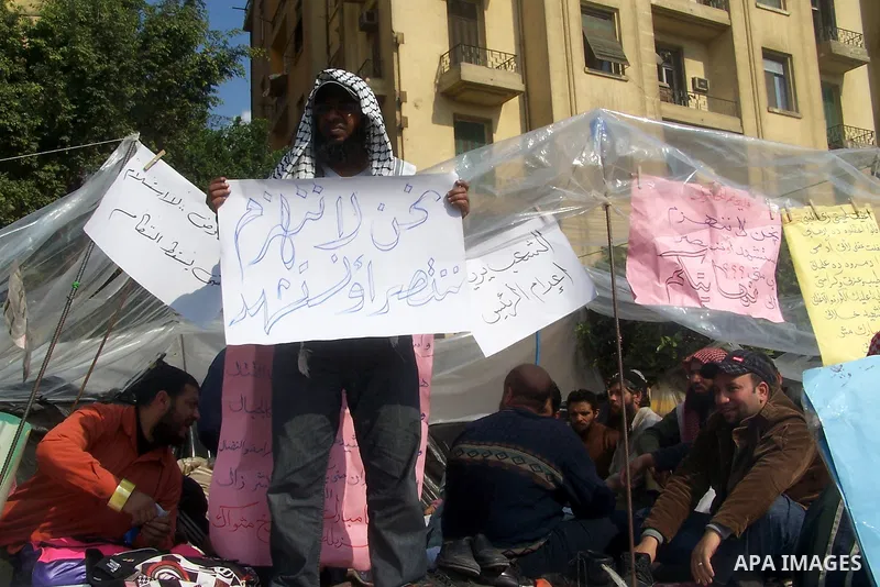 Anti-government protesters gather in front the state television building in Cairo, Egypt, Friday, Feb. 11, 2011. Mubarak has refused to step down or leave the country, and instead handed his administrative powers to his...