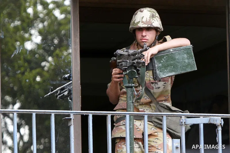 Egyptian Army soldiers stand guards at the state television building in Cairo, Egypt, Friday, Feb. 11, 2011. Mubarak has refused to step down or leave the country, and instead handed his administrative powers to his vice...