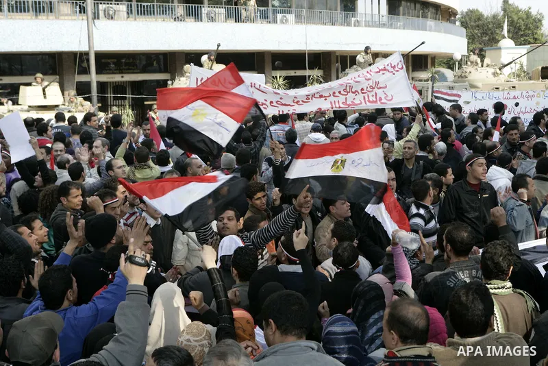 Anti-government protesters gather in front the state television building in Cairo, Egypt, Friday, Feb. 11, 2011. Mubarak has refused to step down or leave the country, and instead handed his administrative powers to his...