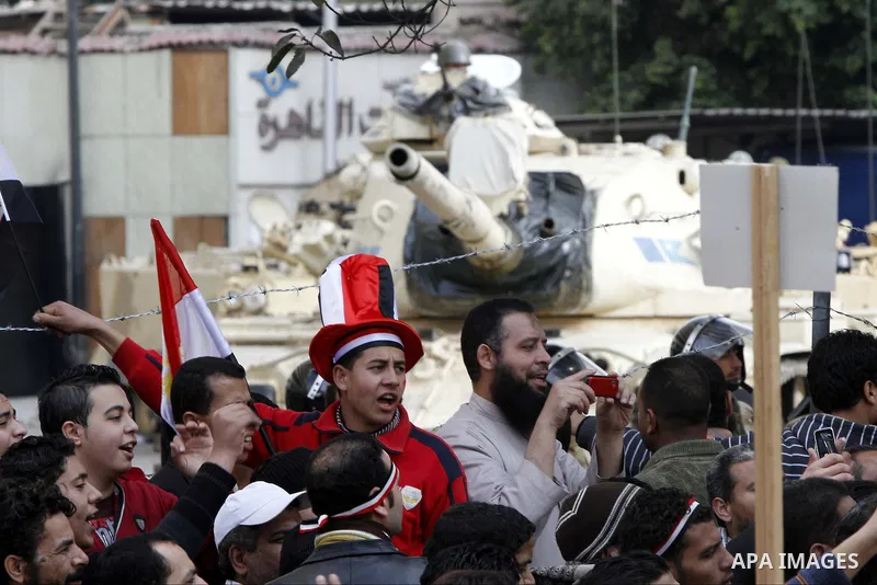Anti-government protesters gather in front the state television building in Cairo, Egypt, Friday, Feb. 11, 2011. Mubarak has refused to step down or leave the country, and instead handed his administrative powers to his...