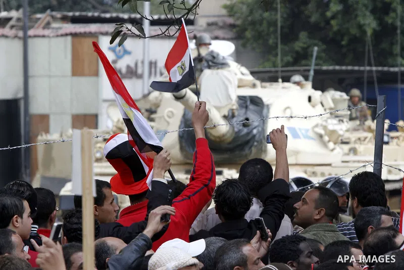Anti-government protesters gather in front the state television building in Cairo, Egypt, Friday, Feb. 11, 2011. Mubarak has refused to step down or leave the country, and instead handed his administrative powers to his...