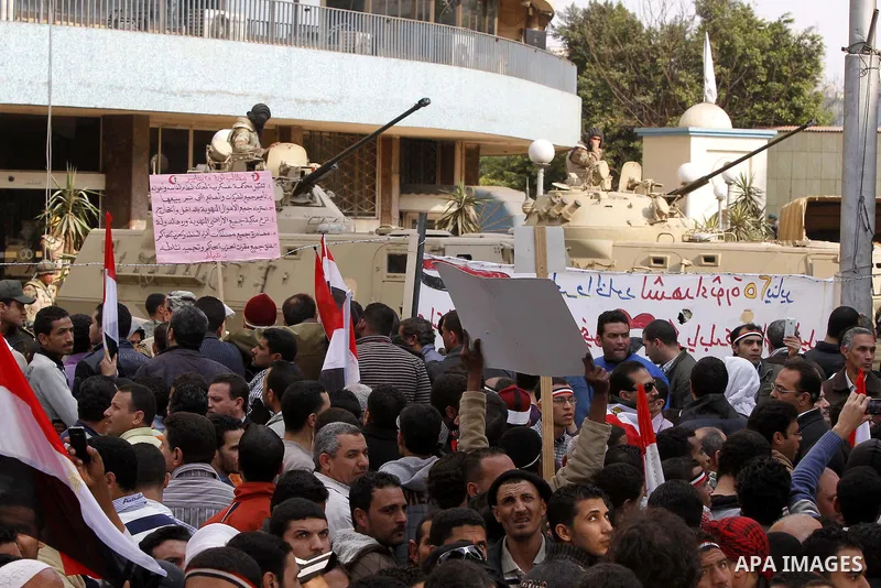 Anti-government protesters gather in front the state television building in Cairo, Egypt, Friday, Feb. 11, 2011. Mubarak has refused to step down or leave the country, and instead handed his administrative powers to his...