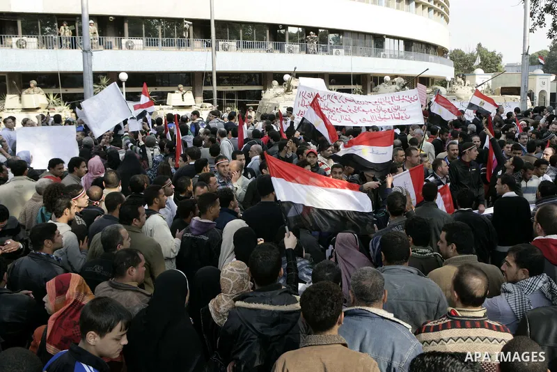 Anti-government protesters gather in front the state television building in Cairo, Egypt, Friday, Feb. 11, 2011. Mubarak has refused to step down or leave the country, and instead handed his administrative powers to his...