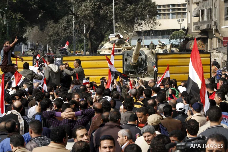 Anti-government protesters gather in front the state television building in Cairo, Egypt, Friday, Feb. 11, 2011. Mubarak has refused to step down or leave the country, and instead handed his administrative powers to his...