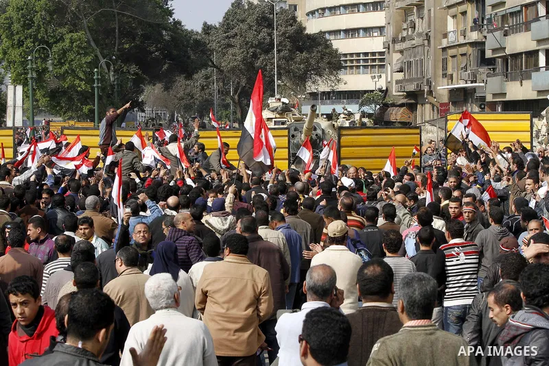 Anti-government protesters gather in front the state television building in Cairo, Egypt, Friday, Feb. 11, 2011. Mubarak has refused to step down or leave the country, and instead handed his administrative powers to his...