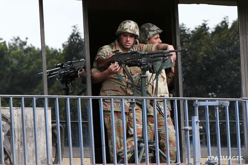 Egyptian Army soldiers stand guards at the state television building in Cairo, Egypt, Friday, Feb. 11, 2011. Mubarak has refused to step down or leave the country, and instead handed his administrative powers to his vice...