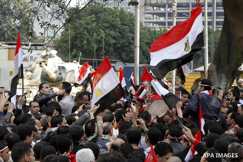 Anti-government protesters gather in front the state television building in Cairo, Egypt, Friday, Feb. 11, 2011. Mubarak has refused to step down or leave the country, and instead handed his administrative powers to his...