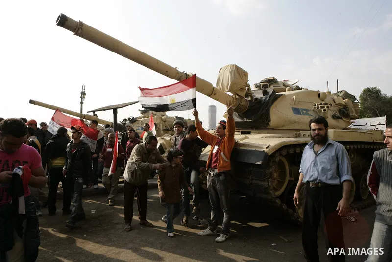 Anti-government protesters gather in front the state television building in Cairo, Egypt, Friday, Feb. 11, 2011. Mubarak has refused to step down or leave the country, and instead handed his administrative powers to his...