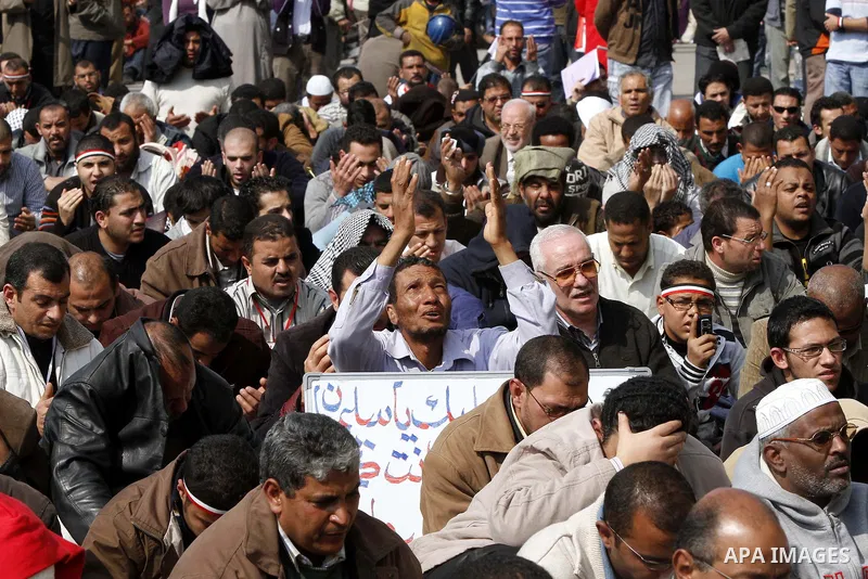 Anti-government protesters gather in front the state television building in Cairo, Egypt, Friday, Feb. 11, 2011. Mubarak has refused to step down or leave the country, and instead handed his administrative powers to his...